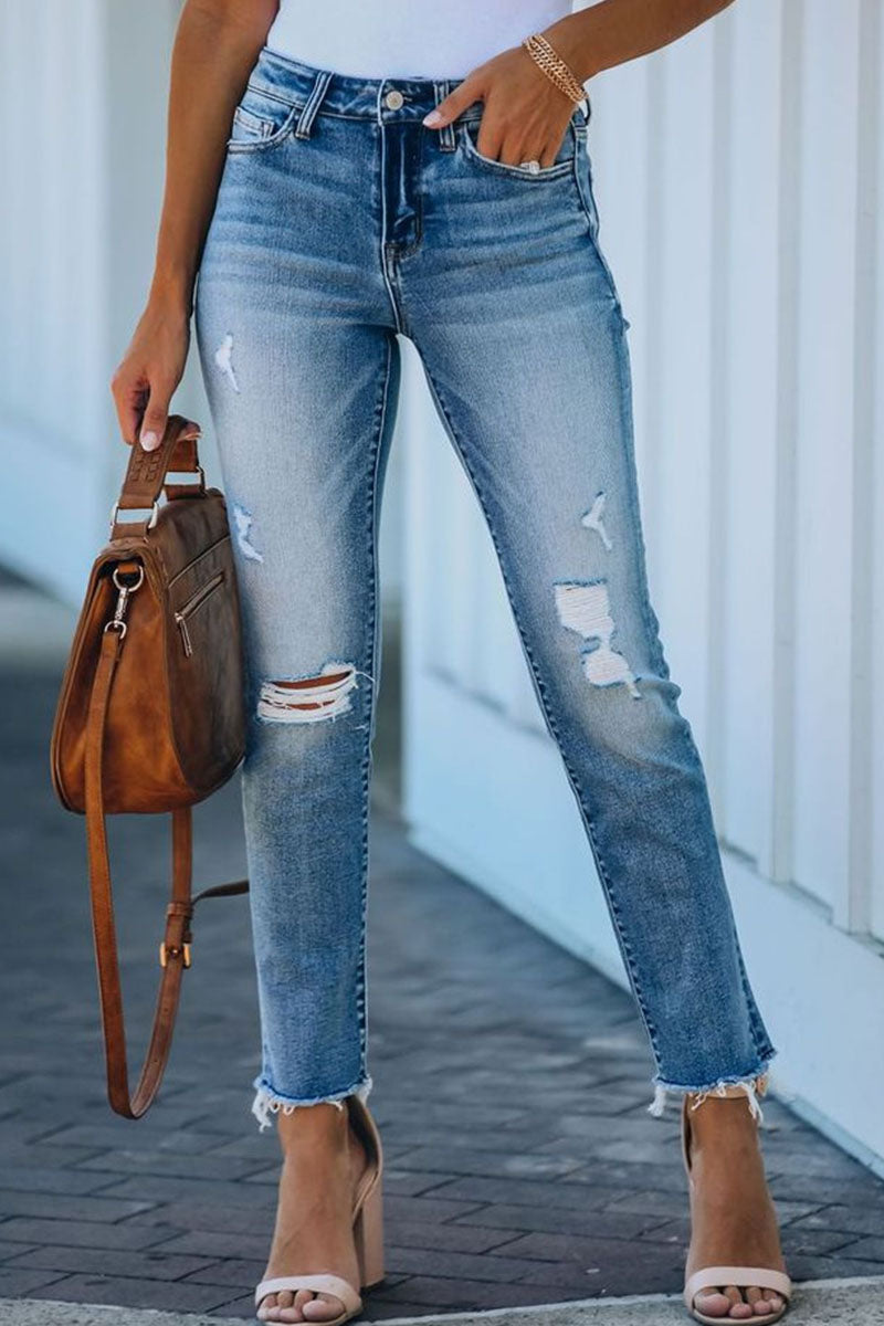 Women's tight skinny jeans with ripped details and an unfinished hemline