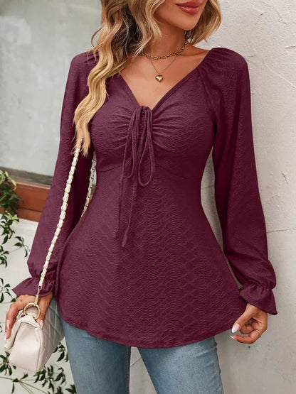 Women's blouse with heart shaped neck balloon sleeves and bow detail at front